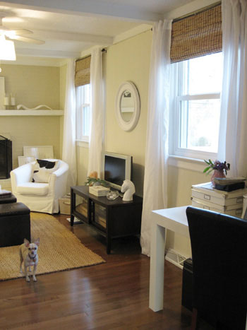 family room den with light walls and floor-to-ceiling white sheer curtains hung layered over natural wood blinds