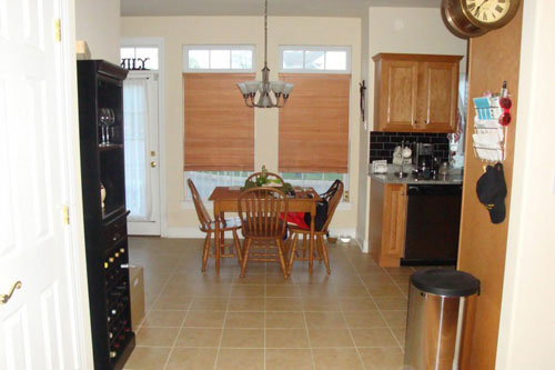 before photo of kitchen breakfast nook with dark blinds covering windows