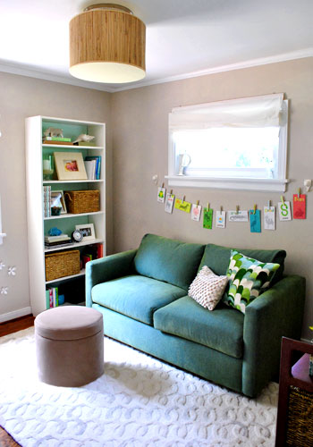 final guest room office with neutral walls and colorful green sofa