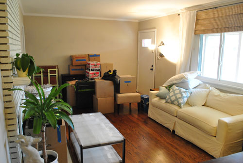 Other Side Of Living Room Filled With Moving Materials and Furniture Padded