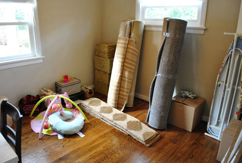 Guest Bedroom With Furniture Packed and Rugs Rolled Up Ready For Moving Truck