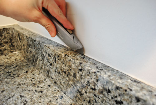 Remove silicone deals caulk from granite