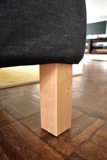 close up detail of ikea sectional sofa legs in unfinished blonde wood