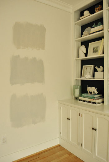 testing gray paint swatch colors on the wall during nighttime light