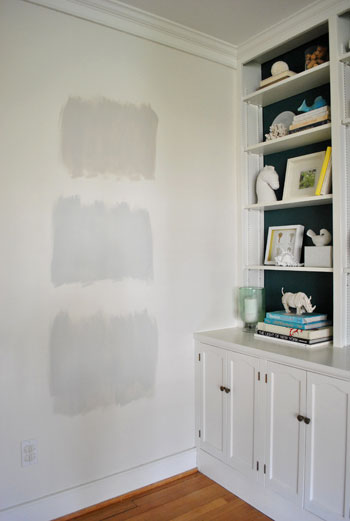 test areas of three Benjamin Moore gray paint colors applies to an area of white wall