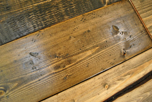 distressed wood look created by hitting bag of screws on whitewood and then staining dark