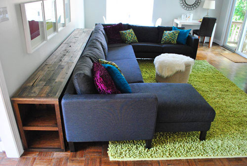 narrow console table behind sofa