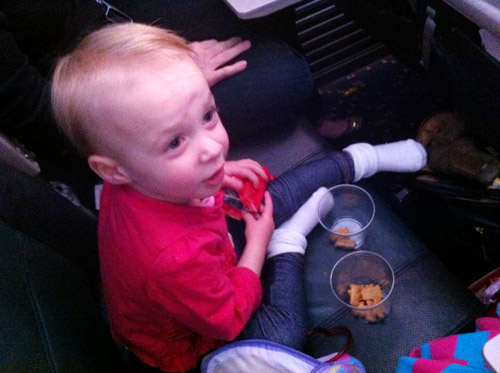 flying with toddler eating snacks on airplane