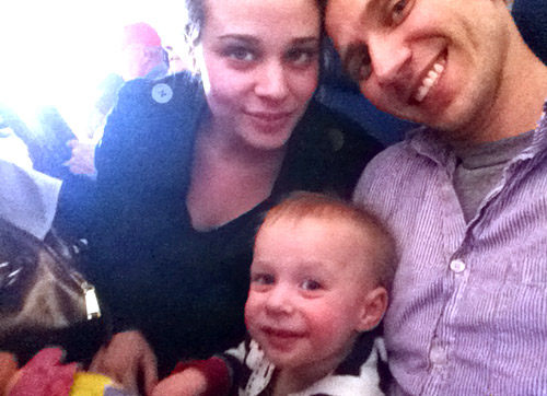 family selfie on airplane with 1 year old