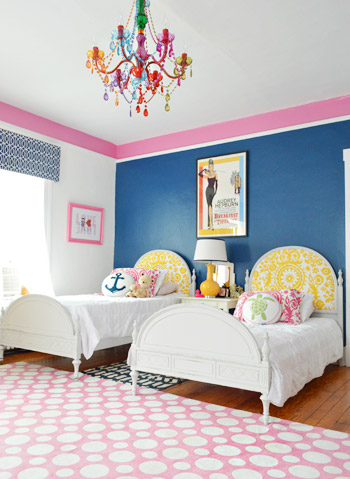 Twin Bed Side-By-Side In Blue Room With Pink Border And Colorful Crystal Chandelier