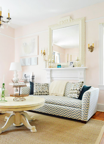 Chevron Print Couch IN Front Of Vintage Fireplace With Oversized Mirror