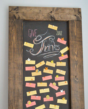 Leaning DIY magnetic chalkboard with Give Thanks lettering in chalk with gratitude notes