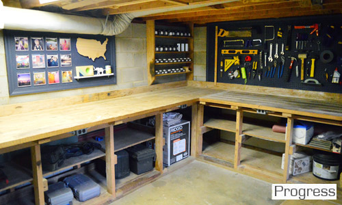 After Photo Of Basement Workshop With Storage Shelves and Blue Painted Pegboards