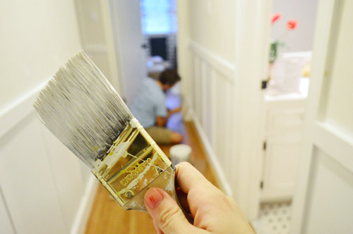short handle angled paint brush preparing to paint a hallway