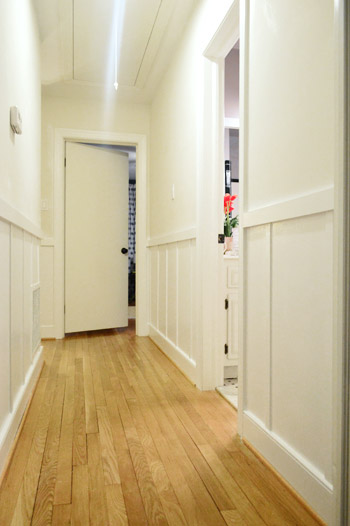 DIY board and batten painted white in hallway before walls are painted