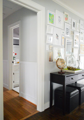 two adjoining hallways with different decor details, including frame gallery wall to wall and the other with board and batten molding