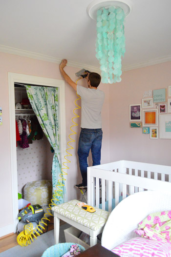 John nailing crown molding to ceiling using compressor and nail gun