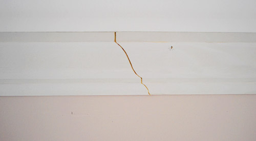 Scarf joint in crown molding where two pieces of molding overlap 