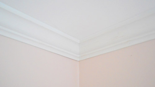 Finished ceiling corner with crown molding installed after caulk