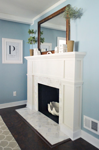 After photo of Modern White Fireplace Surround With Marble Tile