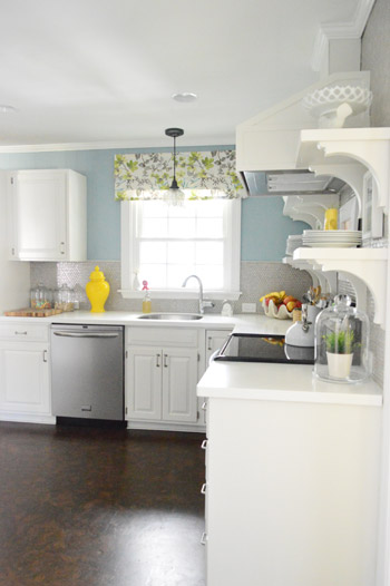 After Photo Of Kitchen With White Cabinets and Floating Shelves With Blue Walls