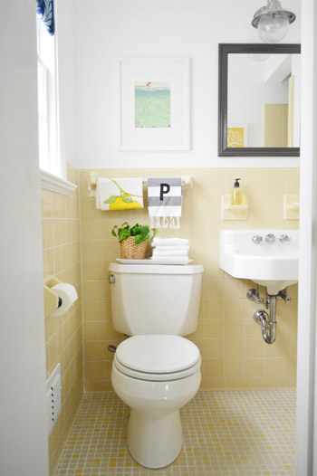 After Photo Of Guest Bathroom With Yellow Tile And Decorative Mirror And Artwork