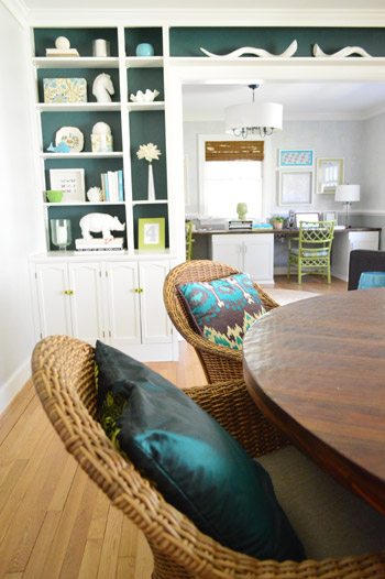 View of Colorful Office Through Living Room With Colorful Built-In Bookcases