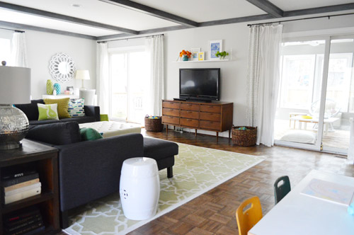 Living Room With Double Sliding Doors With Curtains And Vintage Media Cabinet