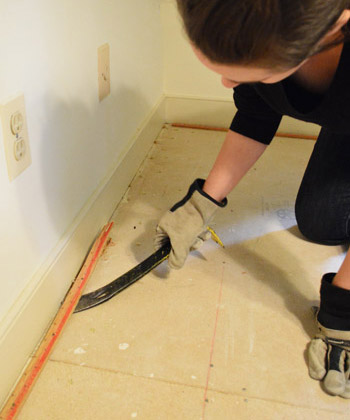 prying up carpet tack strip with crowbar