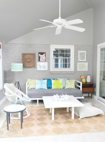 After Photo Of Sunroom With Gray Walls and Frame Collage Over Daybed
