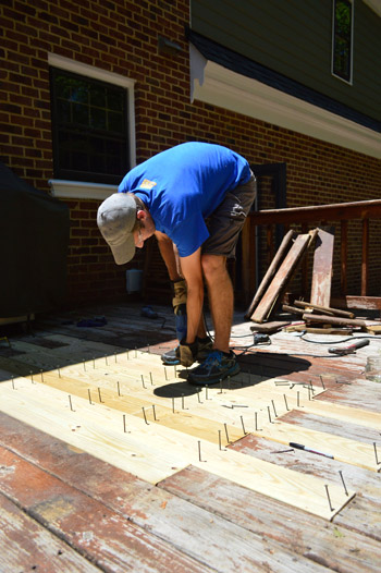 John screwing in new deck boards