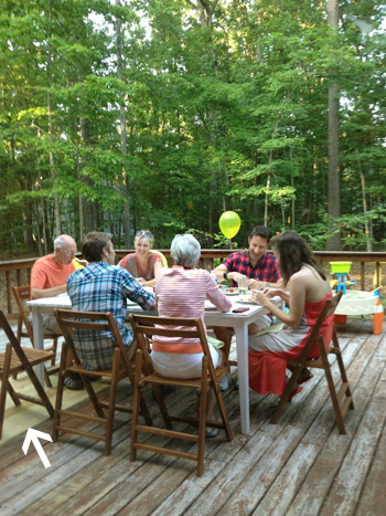 Gathering of people on patched hole in wooden deck