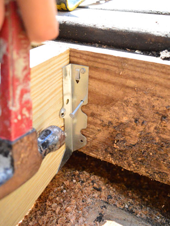 Nailing in metal hangers to repair a hole in the deck