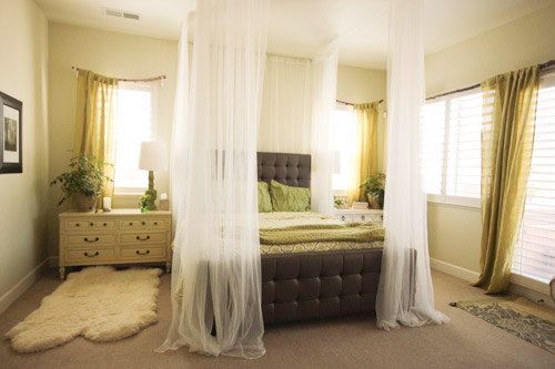 Bed Made Cozy With Curtains Hanging From Ceiling To Mimic Canopy Bed