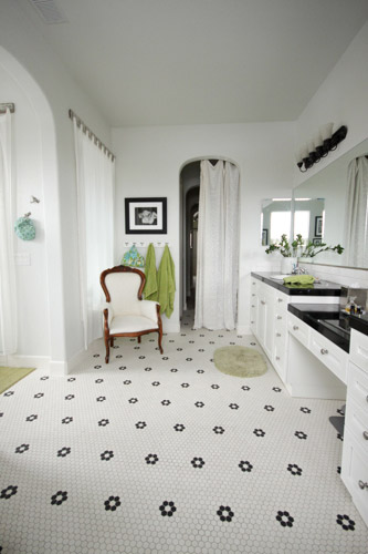 Bathroom With Black and White Hex Tile Floor and Vintage Armchair