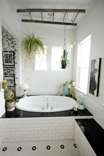 Built-In Bathtub With Ladder Hanging On Ceiling As Plant Display