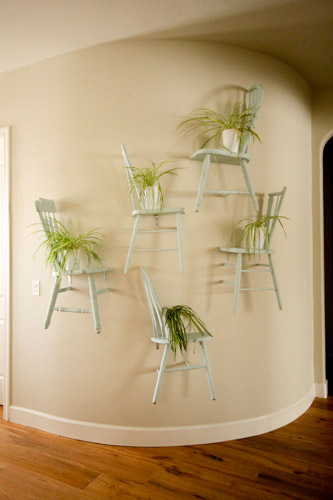 Entryway Display With Vintage Chairs Cut In Half And Mounted To Wall With Plants