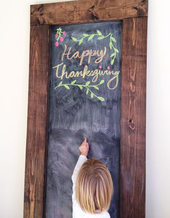 Oversized DIY chalkboard with Happy Thanksgiving message drawn in chalk