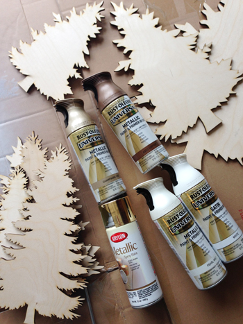 Wood Christmas Pine Tree Cut Outs Before Painting With Cans Of Spray Paint