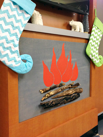Finished faux fireplace with holiday decorations and stockings on mantle for Childrens Hospital of Richmond waiting room
