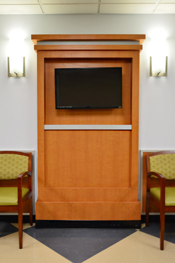 Wood mantle with TV in Childrens Hospital waiting room