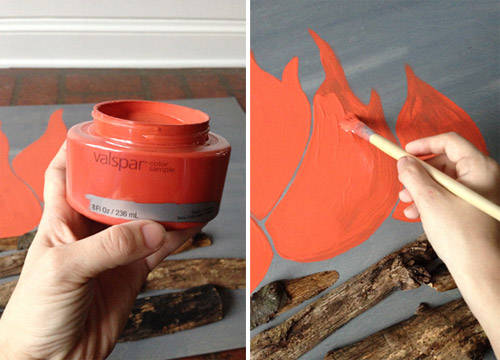 Sherry painting fake flames on DIY faux holiday fireplace