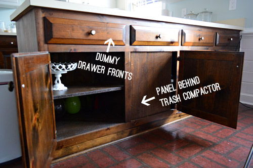 Dummy cabinets and faux cabinet doors in wood stained kitchen