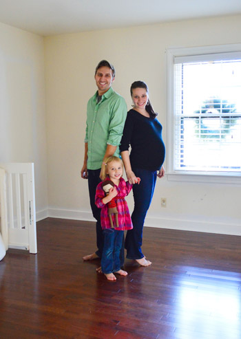 family with pregnant wife in room to turned into nursery