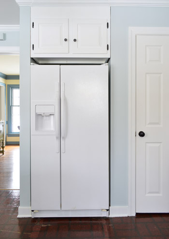 painted white refrigerator in nelson blue kitchen