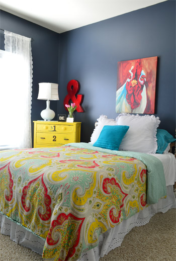 Fun Bedroom With Paisley Bedspread and Yellow Dresser