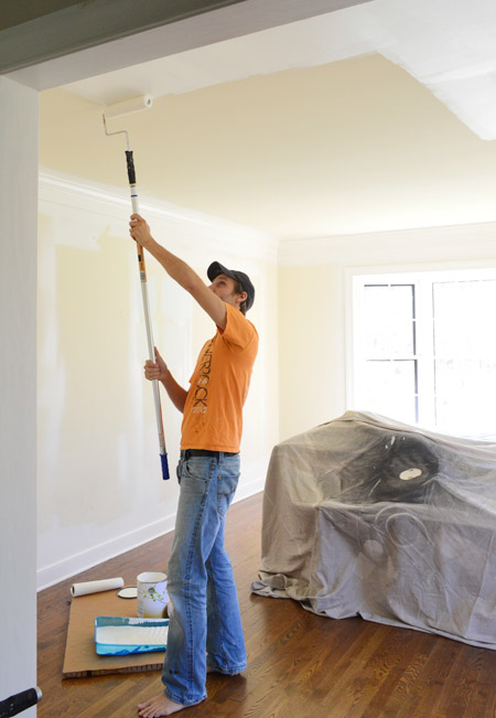 John Applying Paint to Ceiling With Roller On Extension Pole