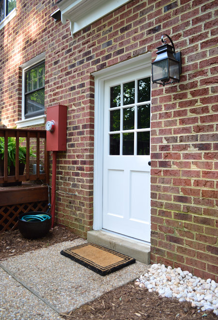 Close Up Of Updated Outdoor Area With Painted Door New Light And Disguised Electrical Box