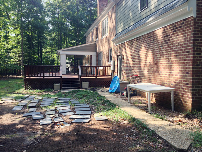 Before Photo of Backyard Area With Messy Unorganized Items After Move In