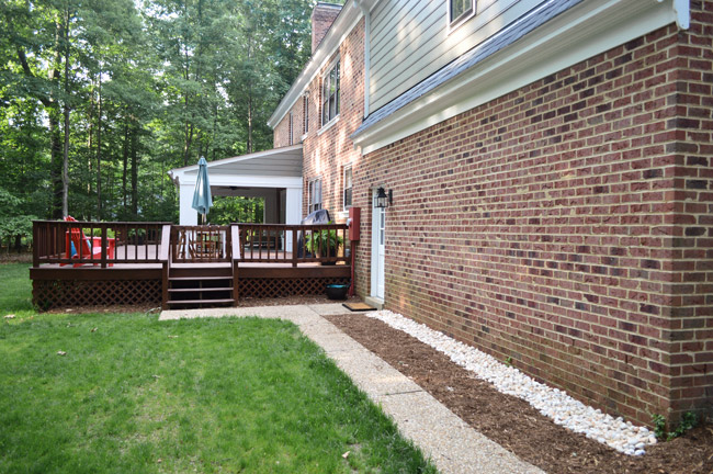 After Photo Of Backyard Area With Cleaner Landscaping And Grass